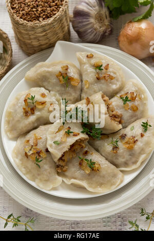 Dumplings with buckwheat porridge and fried onions. This is a very popular food in Poland Stock Photo