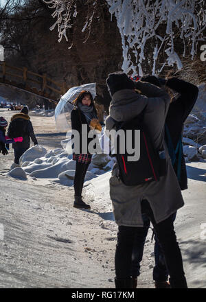 Beautiful Chinese Model Posing for Photographers in the Snow and Ice Stock Photo