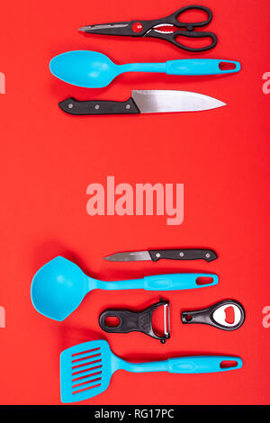 top view of stylish kitchen utensils isolated on red background Stock Photo
