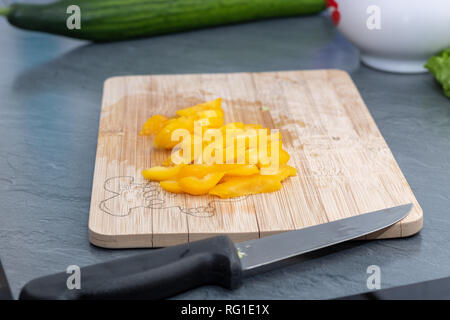 cutting pepper on cutting board at home Stock Photo