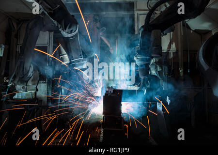 Industrial robots are welding in factory Stock Photo