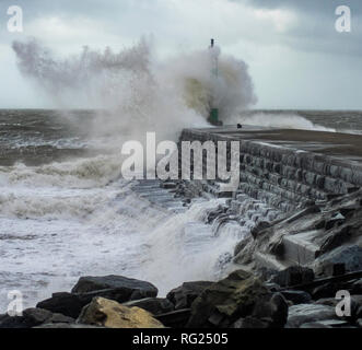 Aberystwyth, Wales, UK. 27 January 2019. Uk Weather: High tide and strong winds produce big waves that smash into the stone jetty in Aberystwyth Mid Wales. Credit: rhodri jones/Alamy Live News Stock Photo