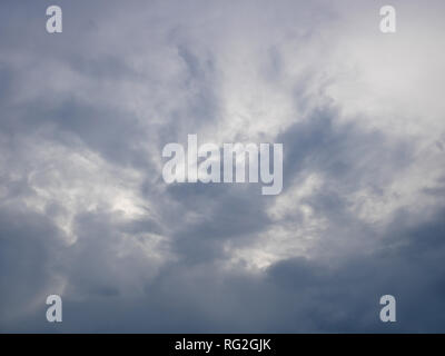 Grey and bluish dramatic cloudscape with various density chaotic thunderclouds Stock Photo