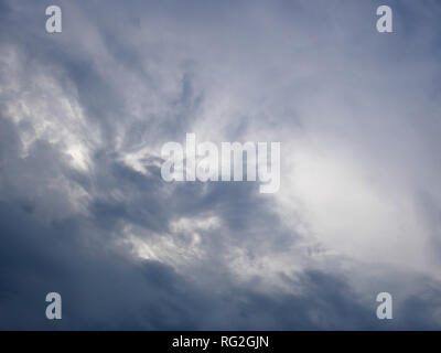 Dark and light bluish tragic cloudscape with various density chaotic thunderclouds Stock Photo
