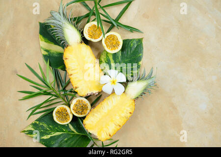 Pineapple Cut Half Maracuja Still Life Top View. Fresh Vegan Breakfast on Green Leaf Decorated with White Flower. Passion Fruit Healthy Diet for Vacat Stock Photo