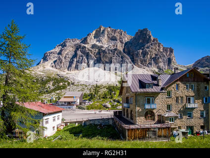 Buildings and Hotels on the Falzarego Pass, Passo di Falzarego, mountains of the Lagazuoi group in the distance Stock Photo