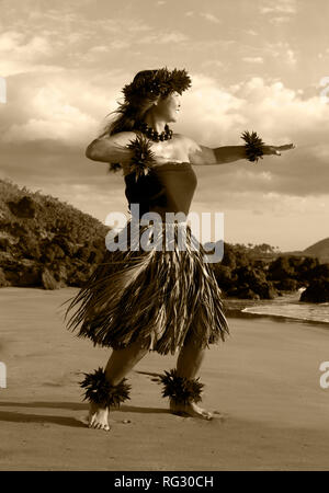 Female hula dancer on the beach at Chang's Beach, Maui, Hawaii. Stock Photo
