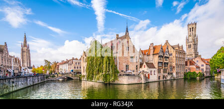 Panoramic city view with historical houses, church, Belfry tower and famous canal in Bruges, Belgium. Stock Photo