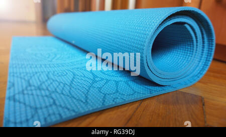 Close up of yoga, fitness floor mat at home in a roll. Healthy concept Stock Photo