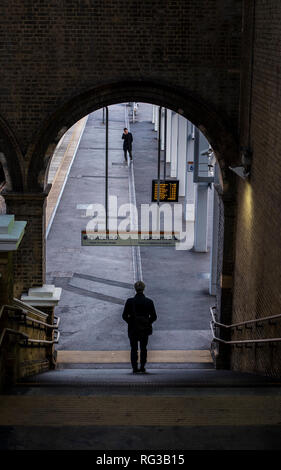 Man walking down slope towards train platform, elevated view, Crystal Palace, London, England, UK Stock Photo