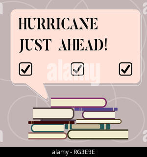 Word writing text Hurricane Just Ahead. Business concept for violent tropical cyclone is approaching to hit the land Uneven Pile of Hardbound Books an Stock Photo