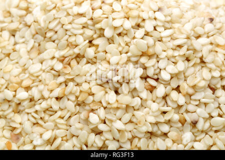 Background of white sesame seeds, macro shot Stock Photo