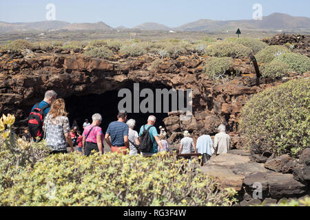 Tourists entering Cueva de los Verdes (Green Caves) a lava tube formed 5000 years ago, close to Jameos del Agua, Haria, Canary Island, Lanzarote Stock Photo