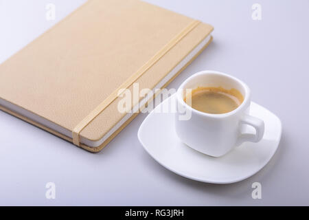 office table with notebook, computer keyboard,, cup of coffee, tablet pc. copy space. Stock Photo