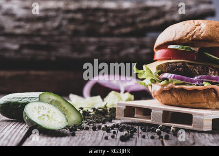 Fresh tasty burger on vintage wooden table, matte effect. Vintage table and background, copy space Stock Photo