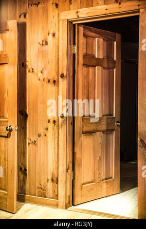 Interior of room with doors and wood paneling inside a beautiful wooden cabin Stock Photo