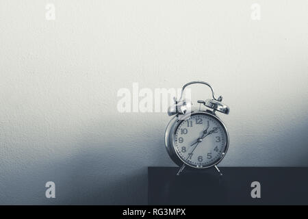 Retro alarm clock on table. Vintage style slate blue photo