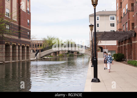 An older woman and her teenage grandson walk along the White River Canal in Indianapolis, Indiana, USA. Stock Photo