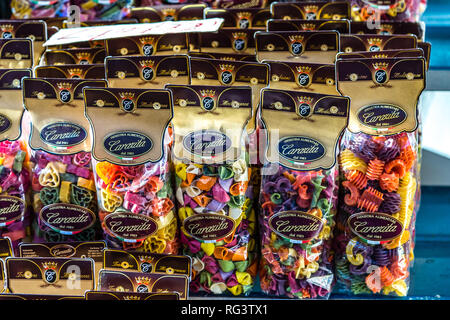 ROME, ITALY - JANUARY 6, 2019: light is enlightening bags of unusual Italian pasta for sale in street market Stock Photo