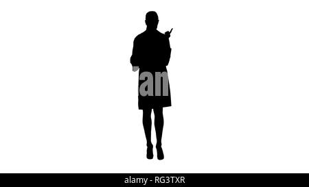 Full length view. Silhouette Doctor female with white labcoat, looking at x-ray radiographic image, ct scan, mri. Professional shot in 4K resolution.  Stock Photo