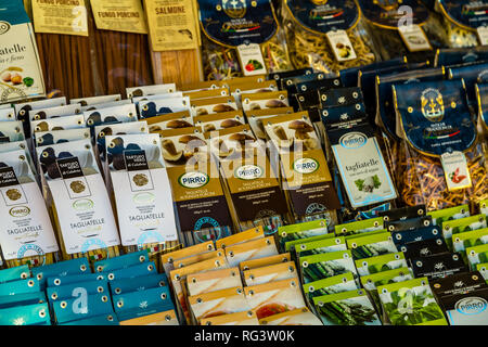 ROME, ITALY - JANUARY 6, 2019: light is enlightening bags of unusual Italian pasta for sale in street market Stock Photo