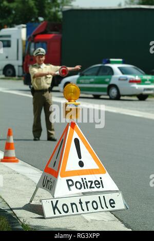DEU, Germany, NRW: Controll of trucks at the highway A4 near Cologne. The police officers check the security of the cargo, the Stock Photo
