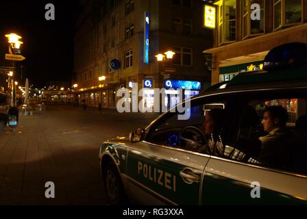 DEU, Germany, Essen: Police car at a night patrol drive in the city center, railway station. Daily police life. Officer from a Stock Photo