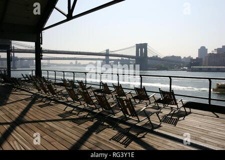 USA, United States of America, New York City: Pier 17, South Street Seaport. Chairs on the observation Deck. East River. Stock Photo