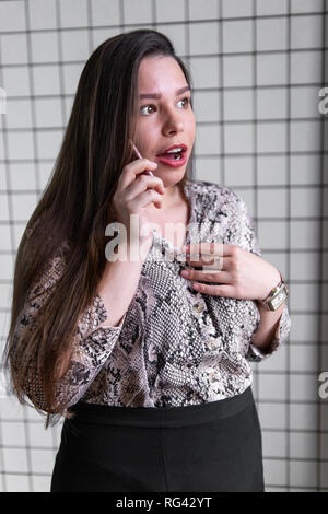 Close up of shocked woman hearing bad news over phone, scared female amazed by negative message received talking on cell, frustrated girl feeling Stock Photo