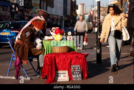 London, England - January 20, 2019. A street performer dressed as the Mad Hatter waits for tourists and shoppers to join him for tea. Stock Photo