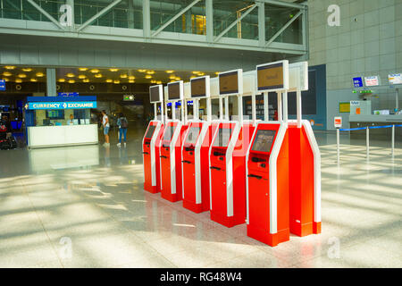 FRANKFURT AM MAIN, GERMANY - AUGUST 29, 2018: Red machines for self service at checkpoint in hall of Frankfurt airport, Germany Stock Photo