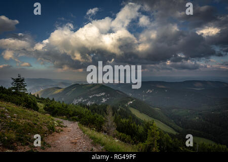 View on rocky path through grassy rax plateau in the cloudy sunset Stock Photo