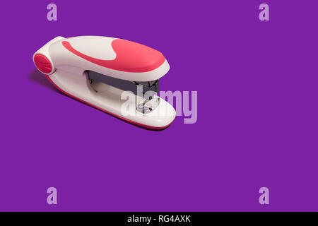 stapler on a purple surface Stock Photo