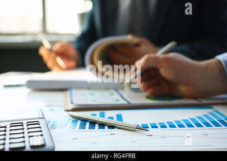 Financial statistics documents ball pen Stock Photo