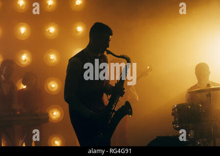 talented saxophone player.silhouette of man playing the saxophone. Stock Photo