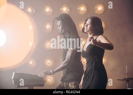 beautiful vocalist girl is singing on the stage. Stock Photo