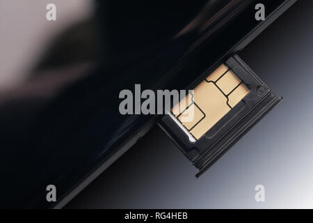 SIM card inserted in smart phone close up. Isolated with clipping path Stock Photo