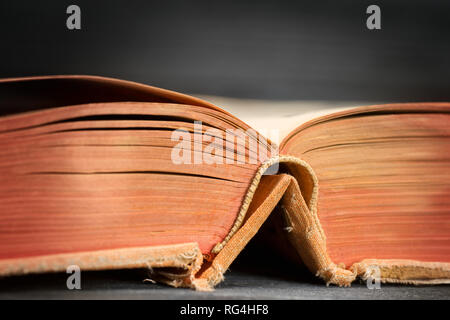 Open ancient book on wooden table close up. Selective focus Stock Photo