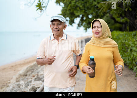 muslim mature couple doing jogging together Stock Photo