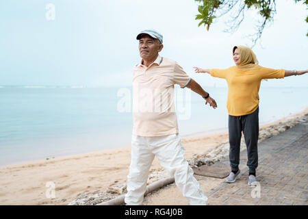 muslim senior couple doing stretching and exercising outdoor  Stock Photo