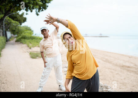 muslim senior couple doing stretching and exercising outdoor  Stock Photo