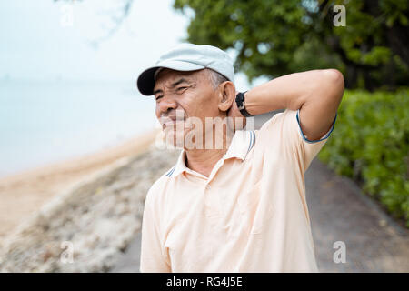 senior male having neck pain Stock Photo