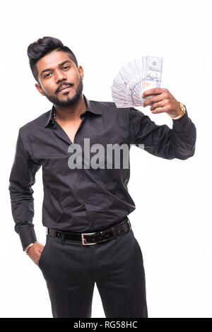 Closeup portrait of super happy excited successful young man holding money dollar bills in hand, isolated on white background. Stock Photo
