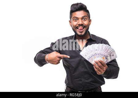 Closeup portrait of super happy excited successful young man holding money dollar bills in hand, isolated on white background. Stock Photo