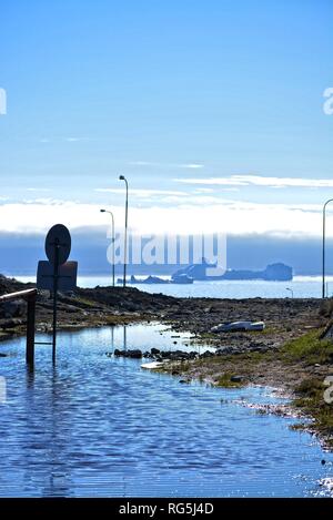 Ilulissat, Greenland, July | midnight sun | impressions of Jakobshavn | road sign - no tresspassing on a flooded road | icebergs in the Disko Bay Stock Photo