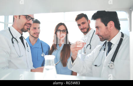 Cheerful young researchers are working in lab Stock Photo