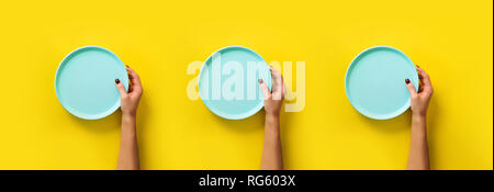 Pattern of female hands holding empty blue plate on yellow background with copy space. Healthy eating, dieting concept. Banner. Stock Photo