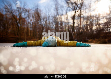 Girl lying on a frozen pond with her arms outstretched, United States Stock Photo