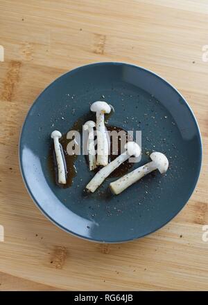 Mushroom with soy sauce and pepper in dish Stock Photo