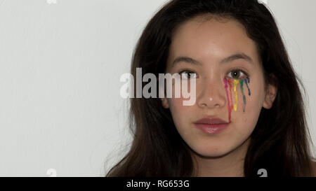 Young teen with colorful tear drops painted on her face Stock Photo